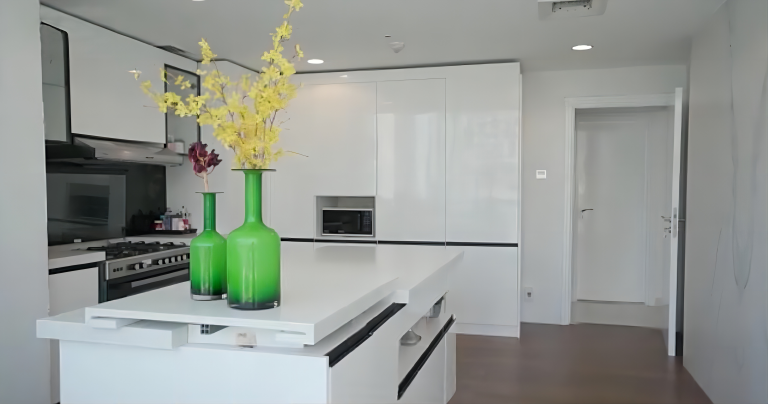 Dubai Luxury Apartment Whole House Custom 3 This Dubai luxury whole house custom project features a modern-style kitchen with frameless white cabinets, handleless doors, and a smooth surface. The white kitchen island adds to the clean and elegant design.
