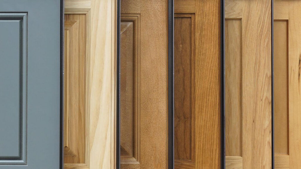 How to choose custom cabinets panels? 35 A selection of different kitchen cabinet door panels with varying colors and wood finishes, showcasing a range of design styles.