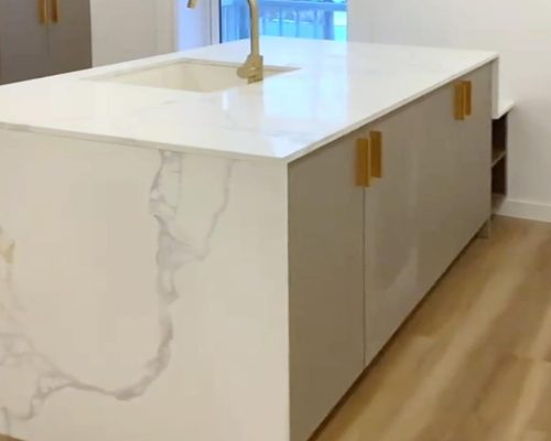 Canada Luxury Apartment Decoration 2 Sleek marble kitchen island with gold faucet in Canada Luxury apartment decoration kitchen design