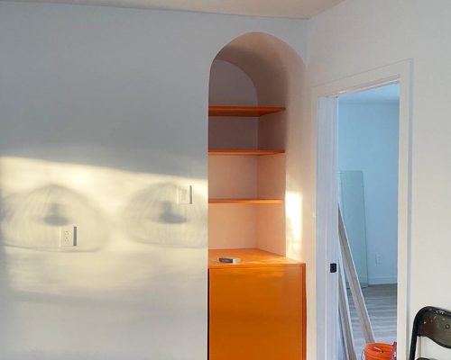 Canada Luxury Apartment Decoration 6 Bold orange alcove cabinet with matching open shelving in modern apartment