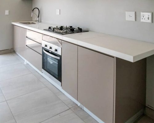 48 Sets Custom Cabinets for Ongwe Holiday Apartment Decoration in Namibia 6 Top view of kitchen cabinets with white counter in Ongwe Apartment.