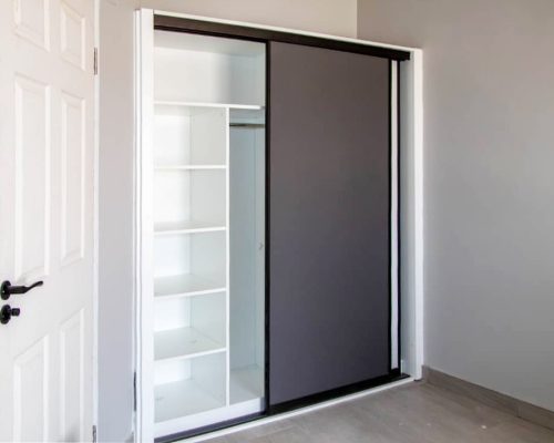 48 Sets Custom Cabinets for Ongwe Holiday Apartment Decoration in Namibia 8 Modern wardrobe with sliding doors and efficient storage in Ongwe Apartment.