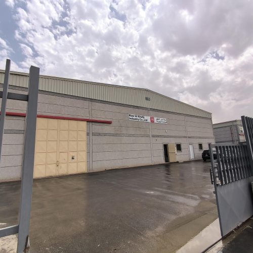 Interior door and wall 36 Jilphar home factory exterior with Nasr Al Khalij Industry Co signage and open gate
