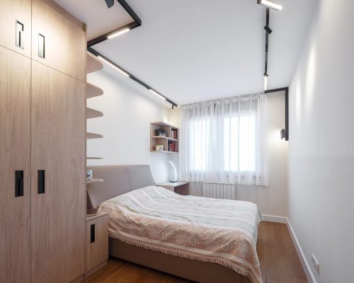 Zemun Stan Whole House custom in Serbia 11 Cozy bedroom with built-in shelves and soft lighting in the Zemun stan apartment whole house custom project.