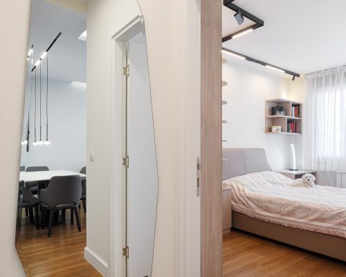 Zemun Stan Whole House custom in Serbia 7 Stylish hallway with a full-length mirror and view of the dining area in the Zemun stan decoration project.