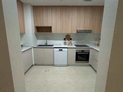 169 Sets Modern Minimalist Apartment Custom Cabinets Project in Dammam 6 U-shaped custom kitchen cabinets in Dammam apartment with light wood upper cabinets and beige base units.