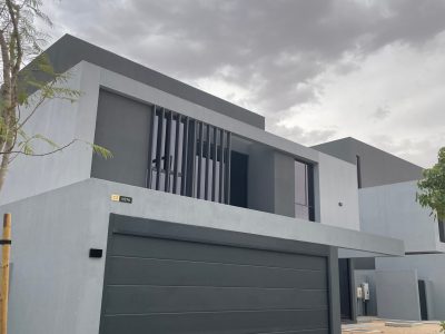 Sharjah Masaar Villa Custom Cabinetry & Garage Door Project 10 Modern dark grey garage door installed on a Sharjah Masaar villa, matching the exterior’s minimalist architectural style.